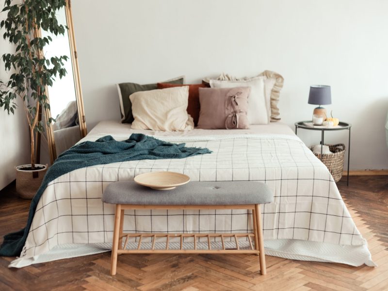 Light bedroom rustic interior with natural materials. Wooden furniture and cotton textiles